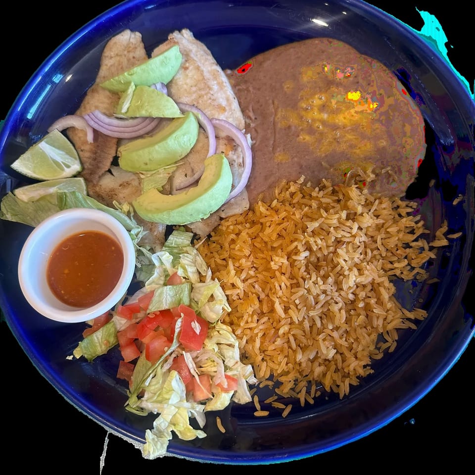 El Tenampa's fish fillet with avocado, onions, rice, refried beans, salad, and salsa.